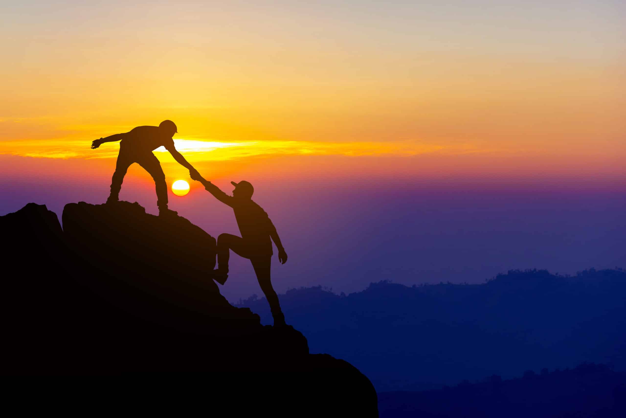 hikers helping each other